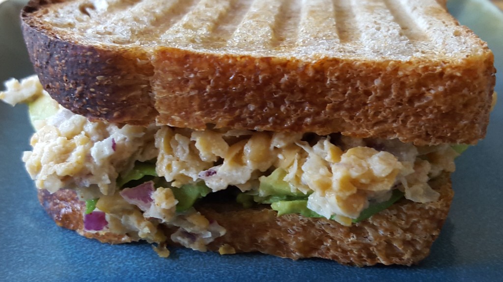 Smashed chickpea sandwich, panini-style, with some avocados hidden inside.